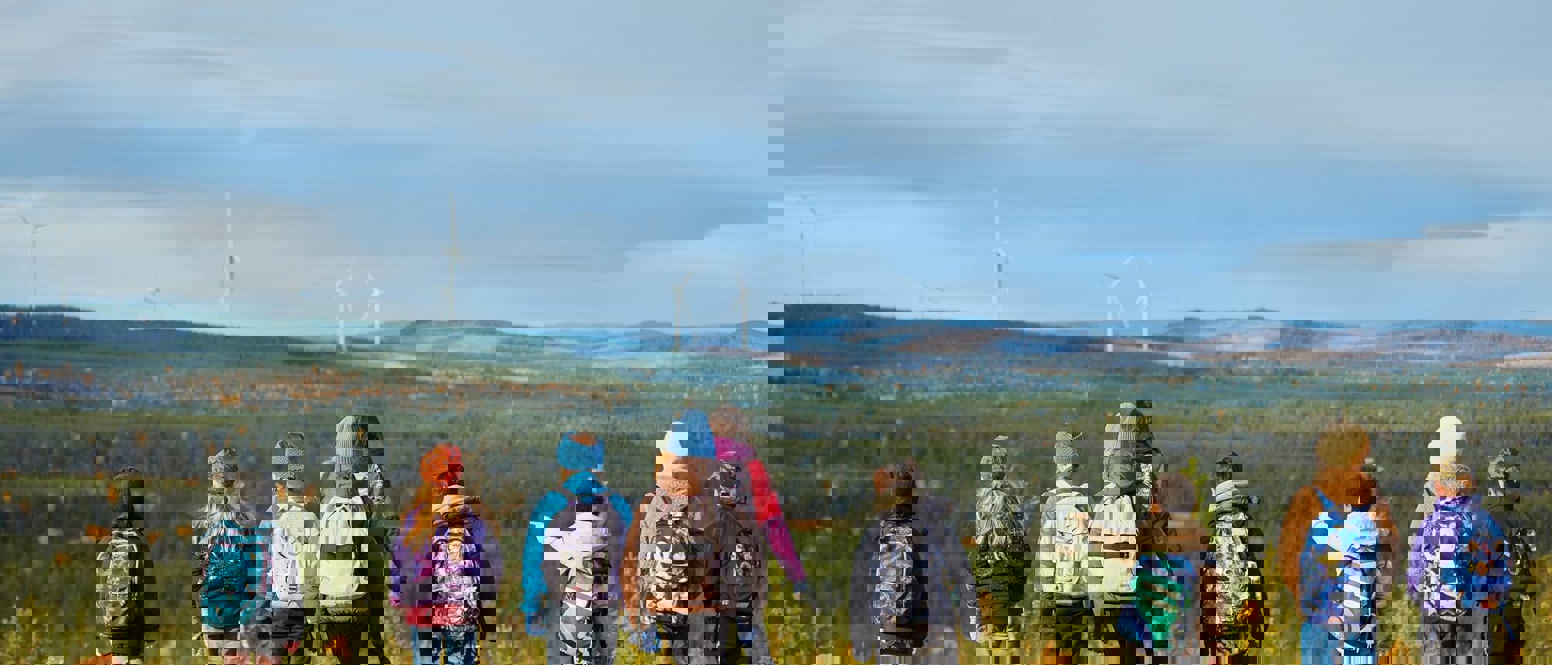 Children looking at a wind farm